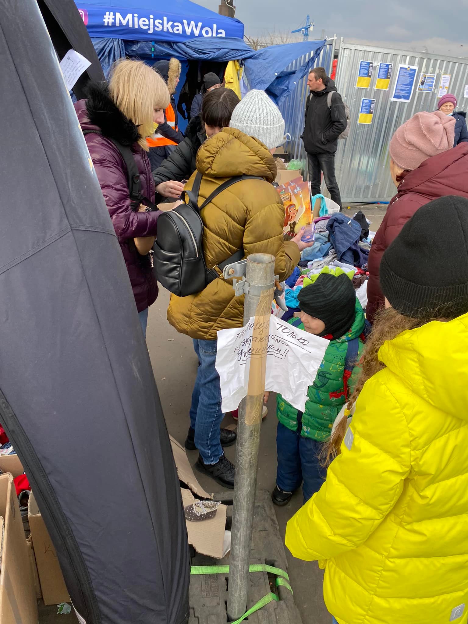 Ukrainian Refugees gathering donated clothes at train station